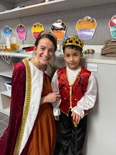 Teacher and student wearing crowns.
