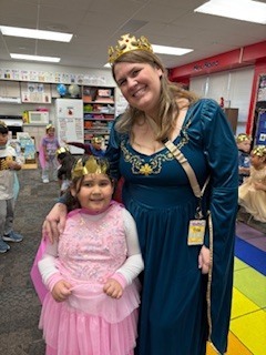 Student with teacher wearing a crown.
