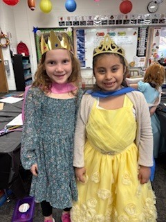 Two students wearing crowns