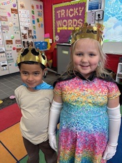 Two students wearing crowns.