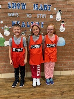 Three students standing by each other. 