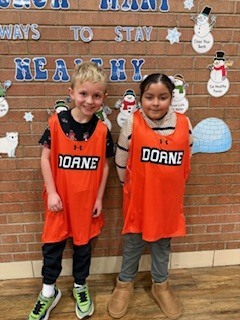 Two students standing by each other. 