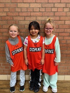 Three kindergarten student standing by each other. 