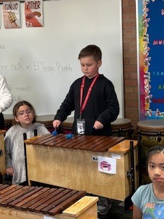 Student playing music instrument.
