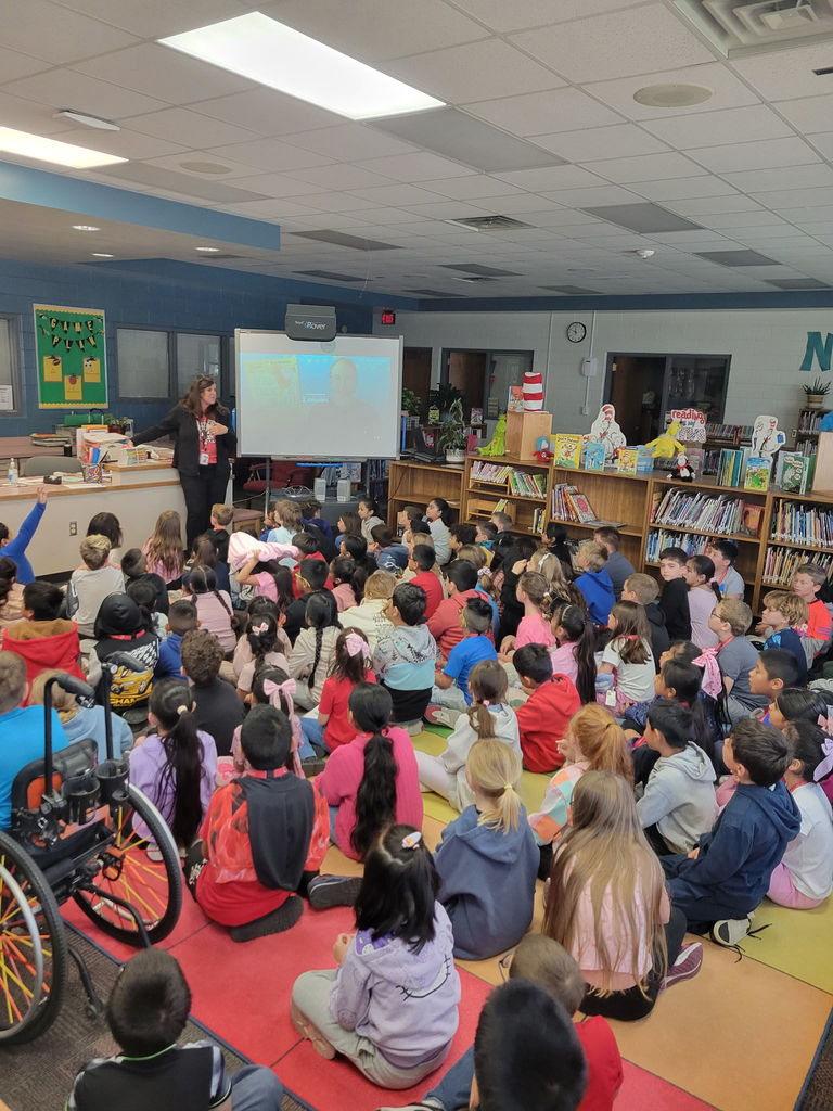 A large group of students in the library. 