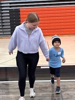 Two students holding hands. 