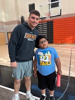 Two students standing by each other.