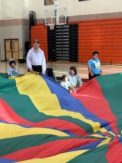 Students holding onto a parachute.