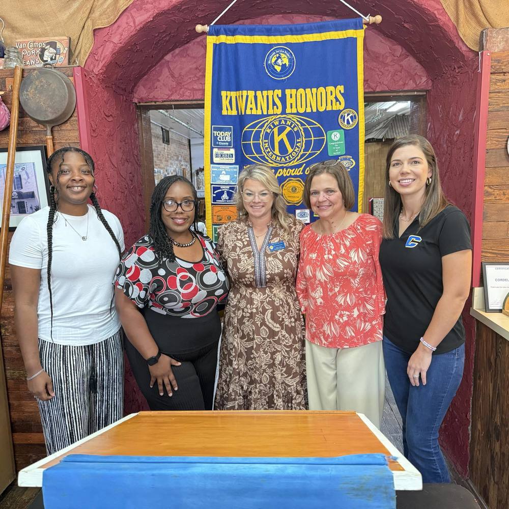 five women standing together as they are presented with a luncheon by the kiwanis club of cordele