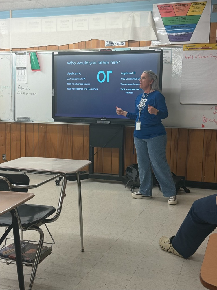Planning for the cap and gown starts now! 🎓 Mrs. West is working with our freshmen today on graduation requirements and GPA math. 