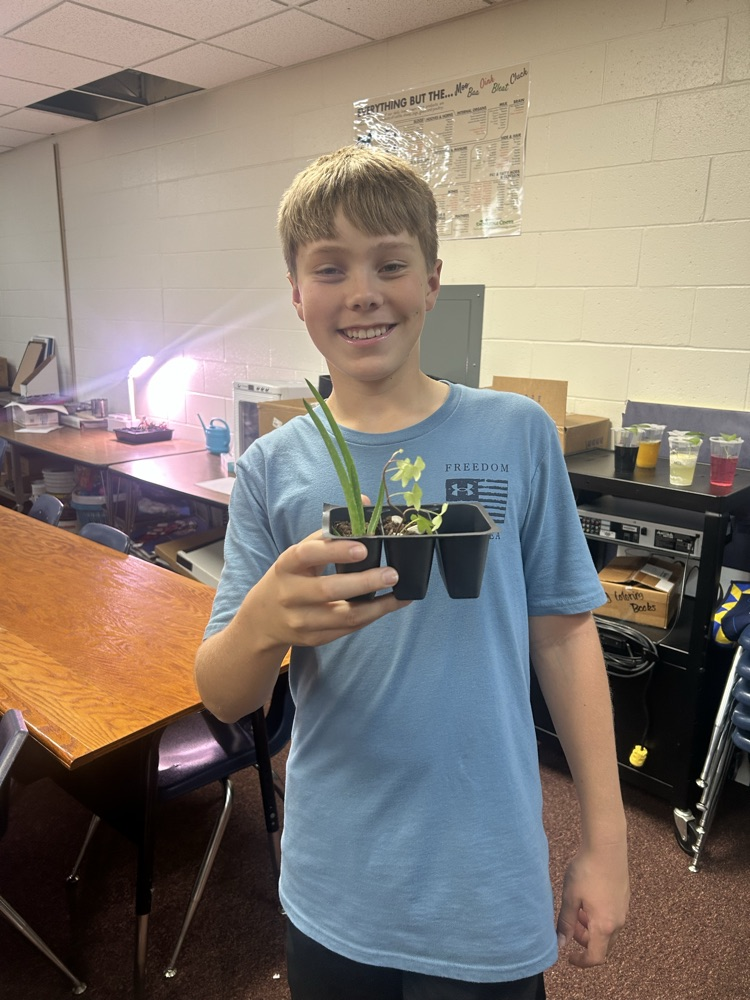 Student with his newly propagated plants
