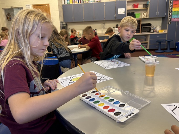 first grader painting with watercolor