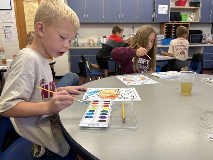 first grader painting with watercolor 