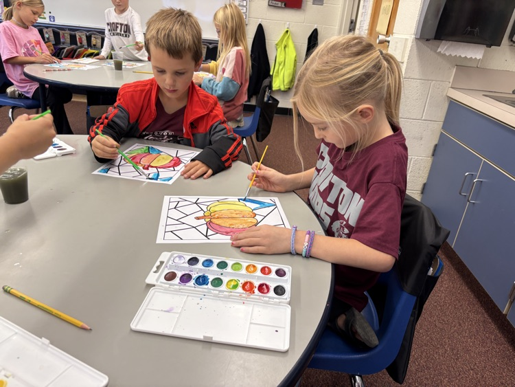 first grader painting with watercolor 