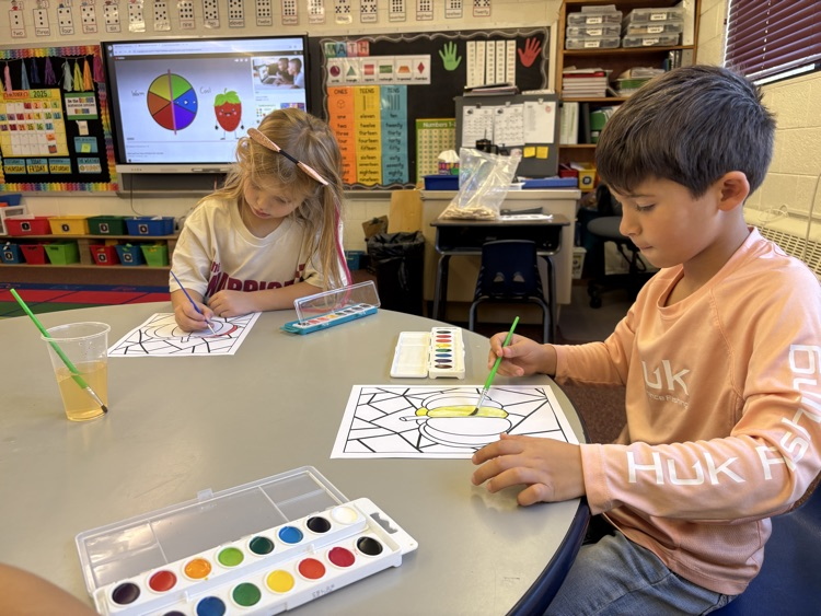 first grader painting with watercolor 