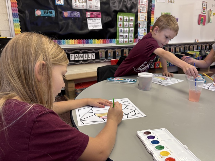 first grader painting with watercolor 