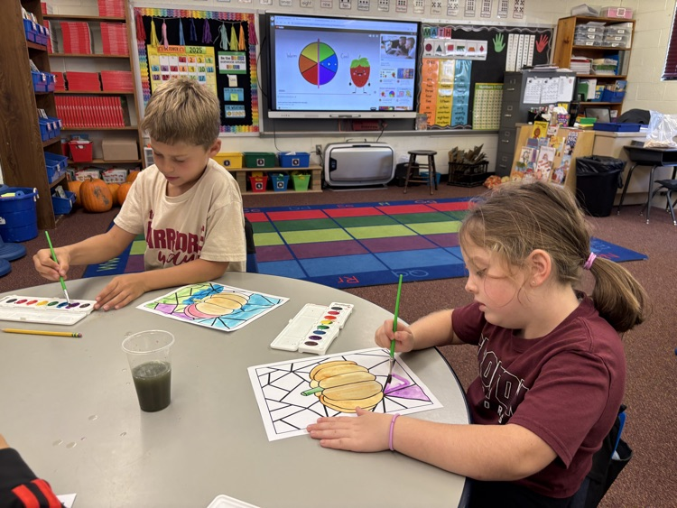 first grader painting with watercolor