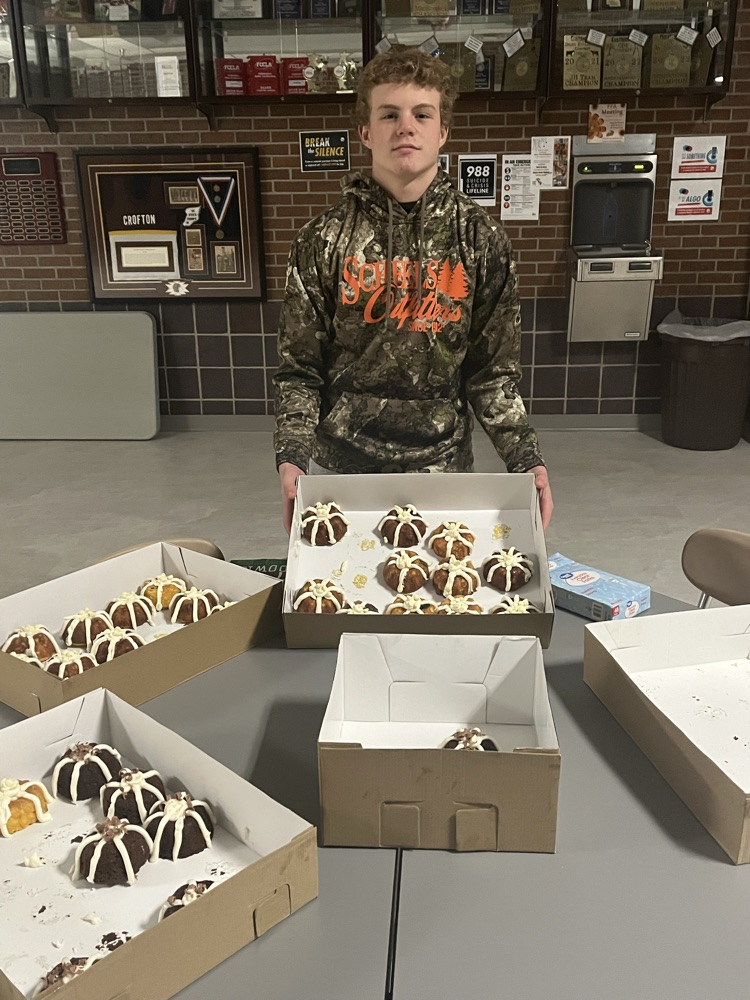 Knox Hegge holding up a box of Bundt cakes