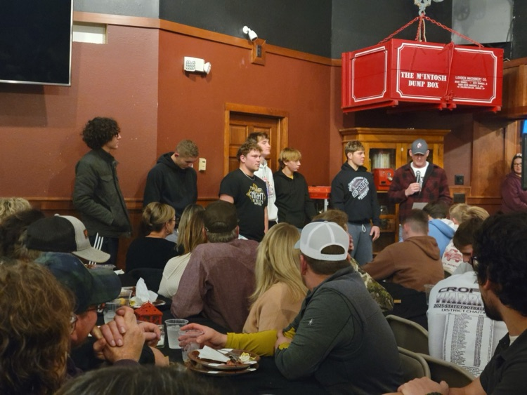 senior football players talking at the team meal