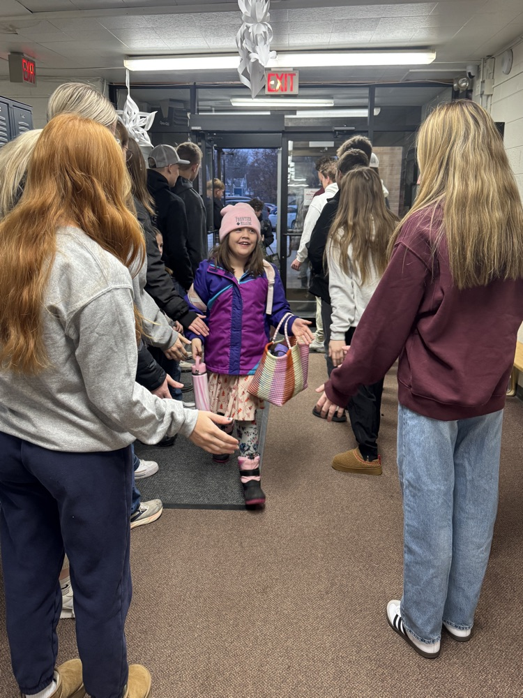 Students smiling getting high fives