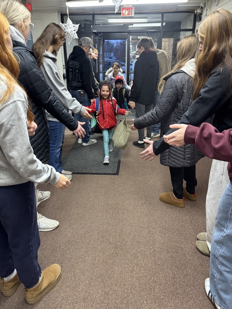Students smiling getting high fives
