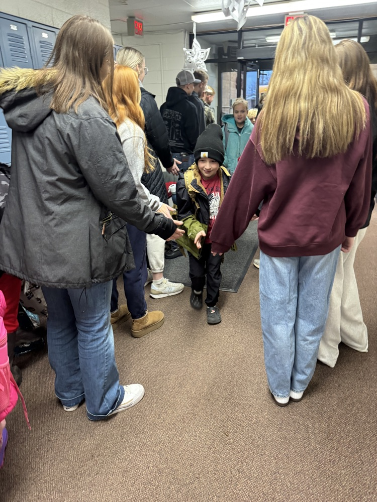 Students smiling getting high fives