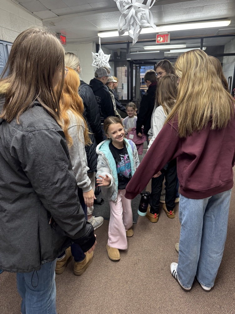Students smiling getting high fives