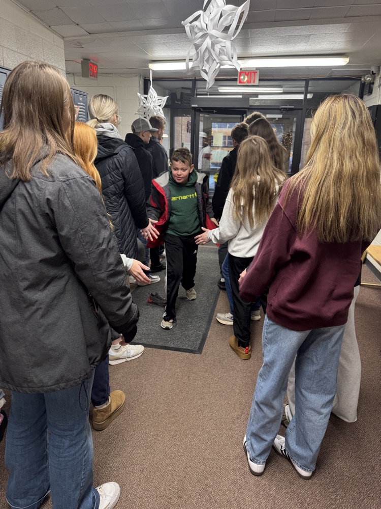 Students smiling getting high fives