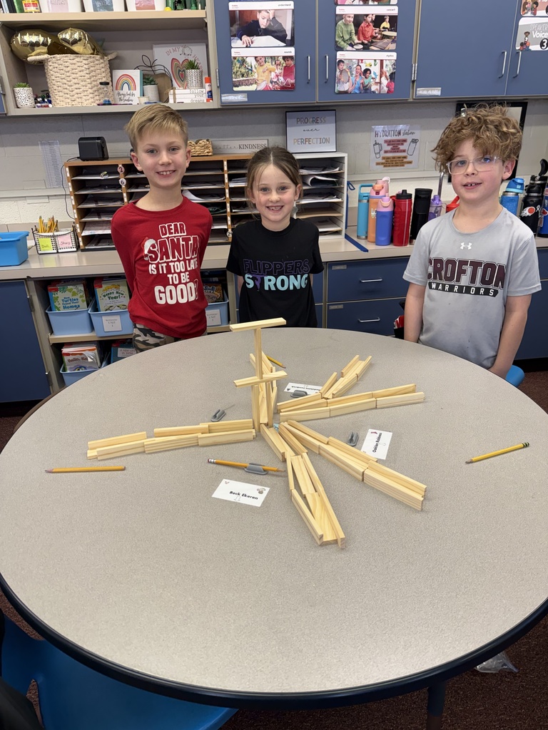 Second grade builds snowflakes with KEVA planks.