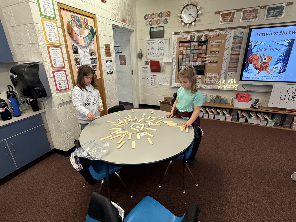 Second grade builds snowflakes with KEVA planks.