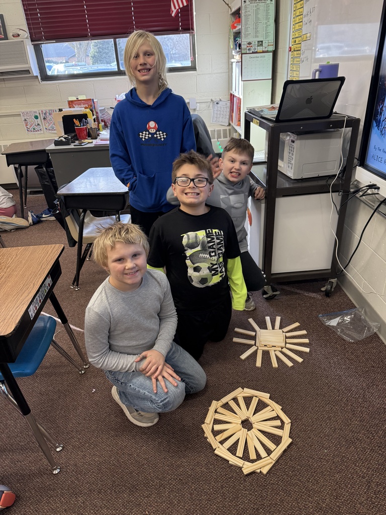 Third grade builds snowflakes with KEVA planks.