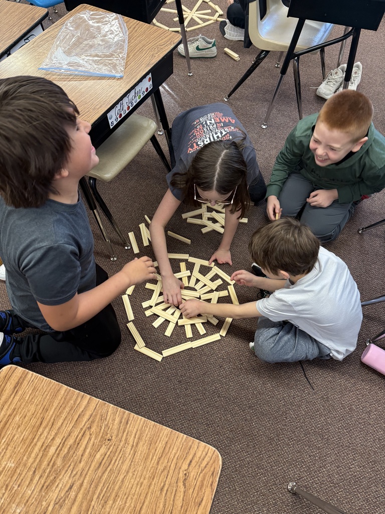 Third grade builds snowflakes with KEVA planks.