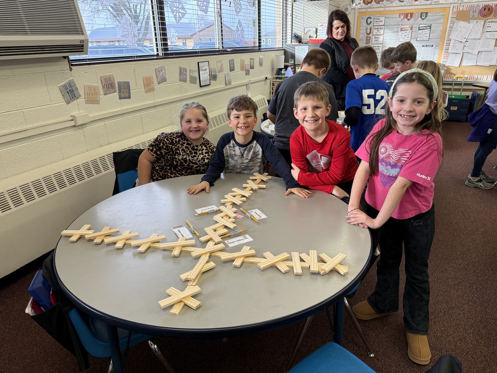 Second grade builds snowflakes with KEVA planks.