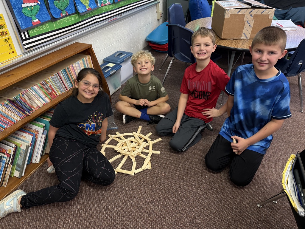 Third grade builds snowflakes with KEVA planks.