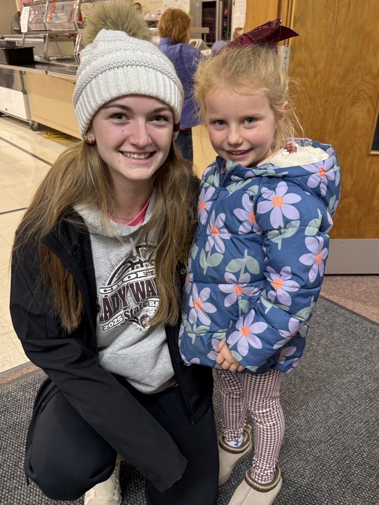 Players taking pics with students 