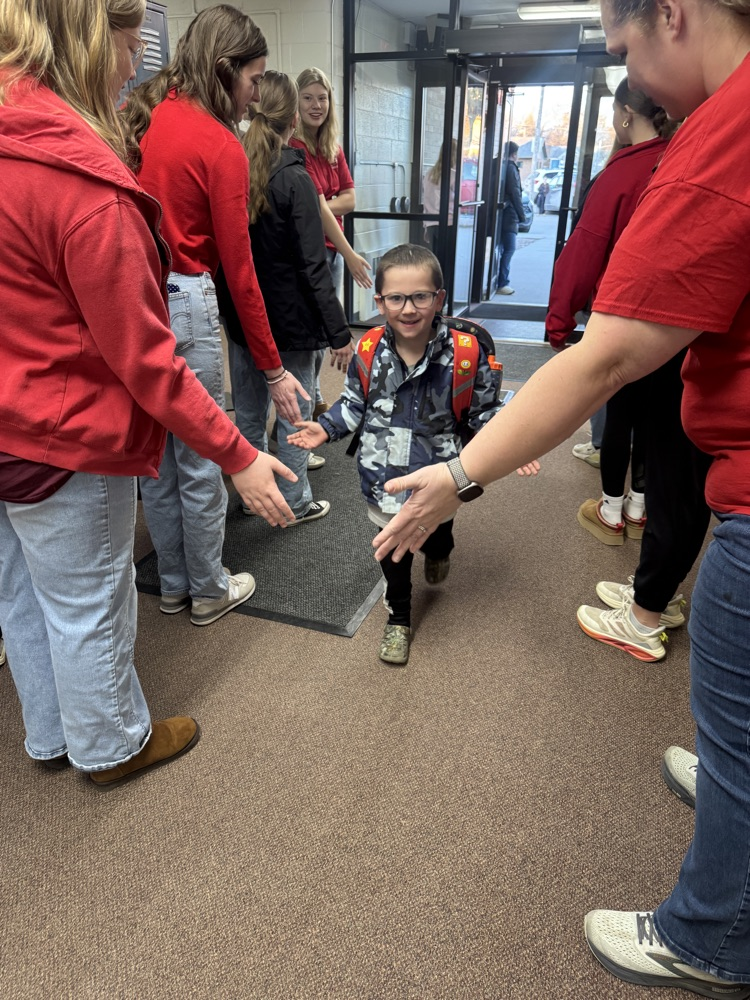 FCCLA members giving high fives to elementary students