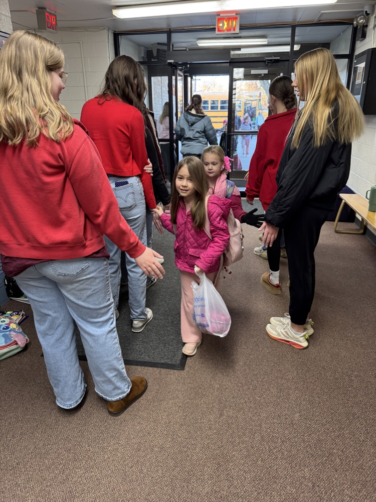 FCCLA members giving high fives to elementary students