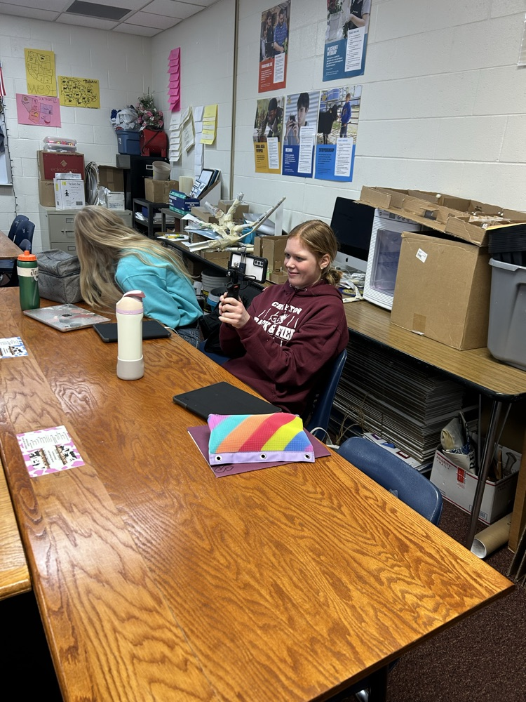 Student holds portable thermal camera