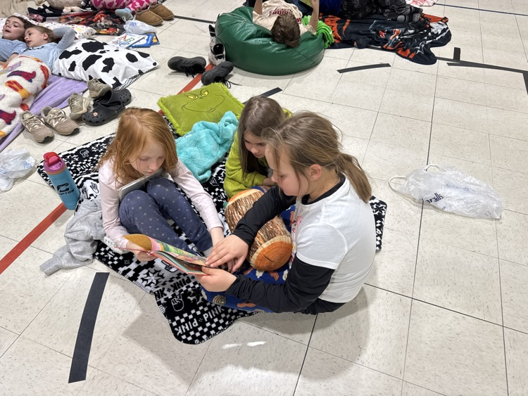 Buddies reading in the gym