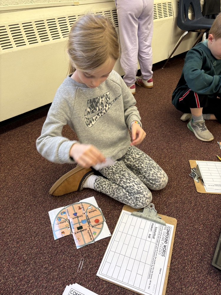 first grader making compound word puzzle