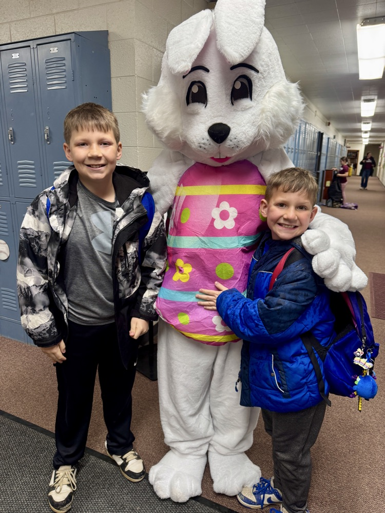 The Leader kids taking a picture with the Easter Bunny 