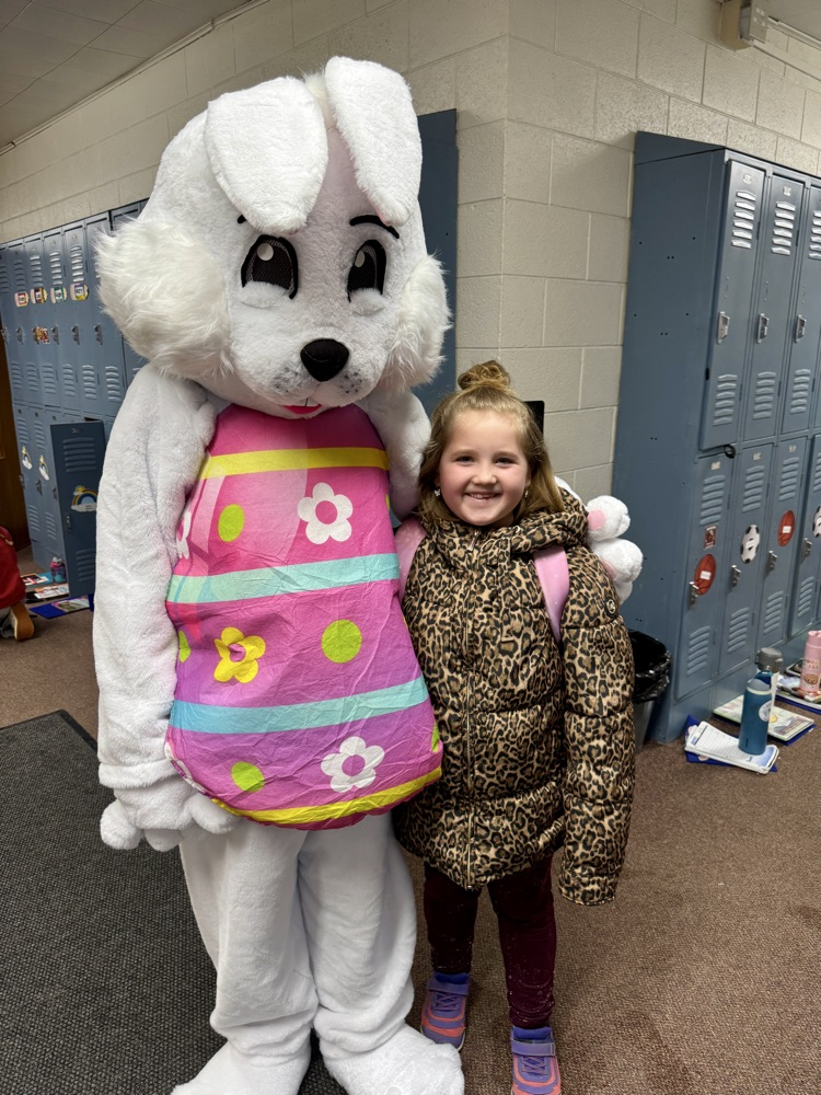 A student taking a picture with the Easter Bunny
