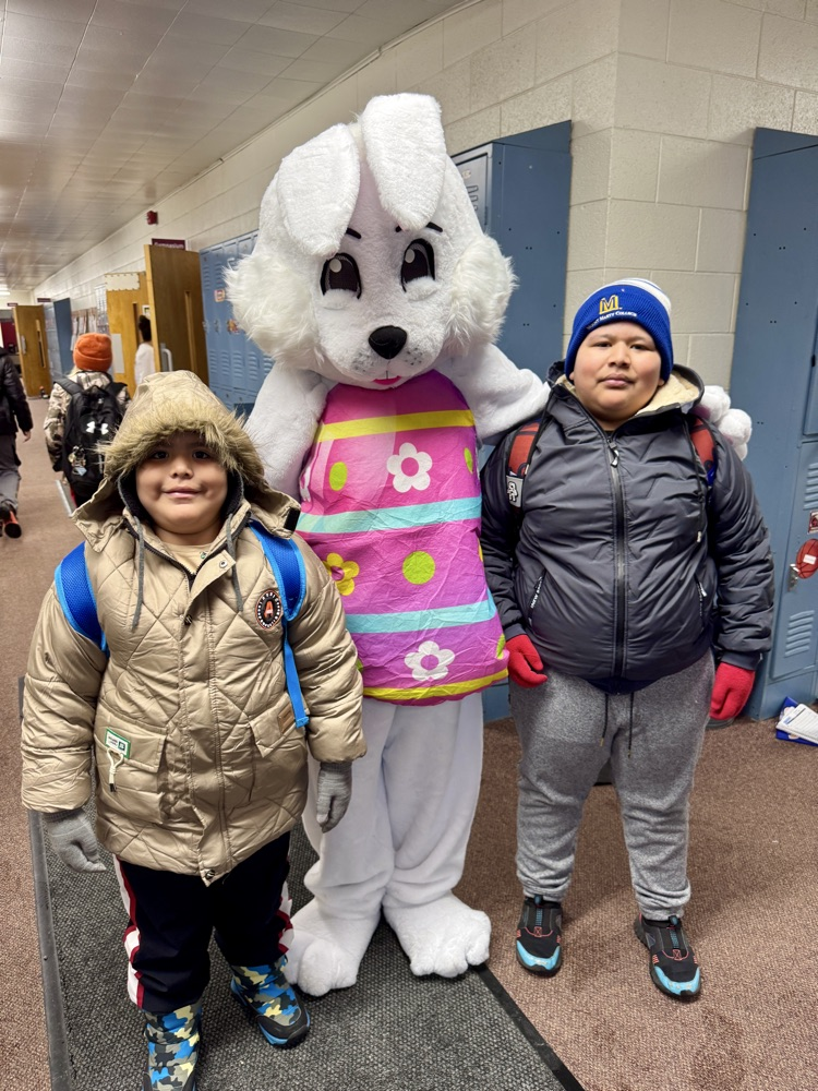 Siblings taking a picture with the Easter Bunny
