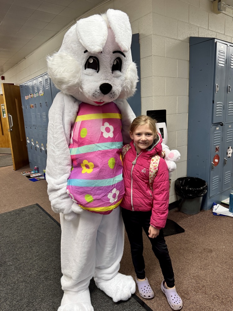A student  taking a picture with the Easter Bunny