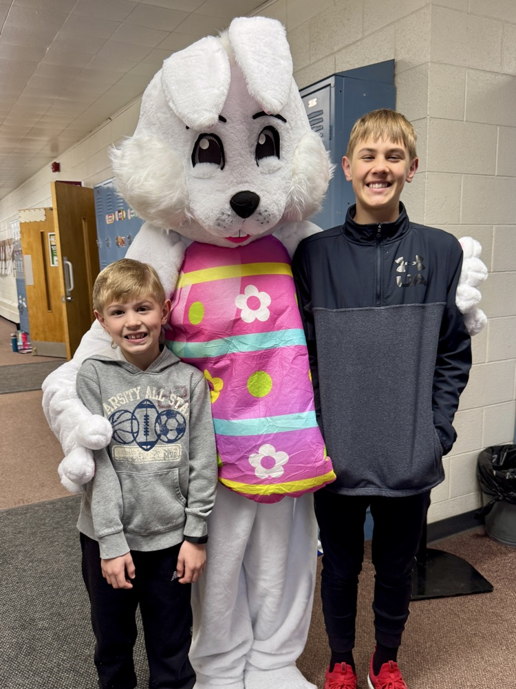 The Leader kids taking a picture with the Easter Bunny