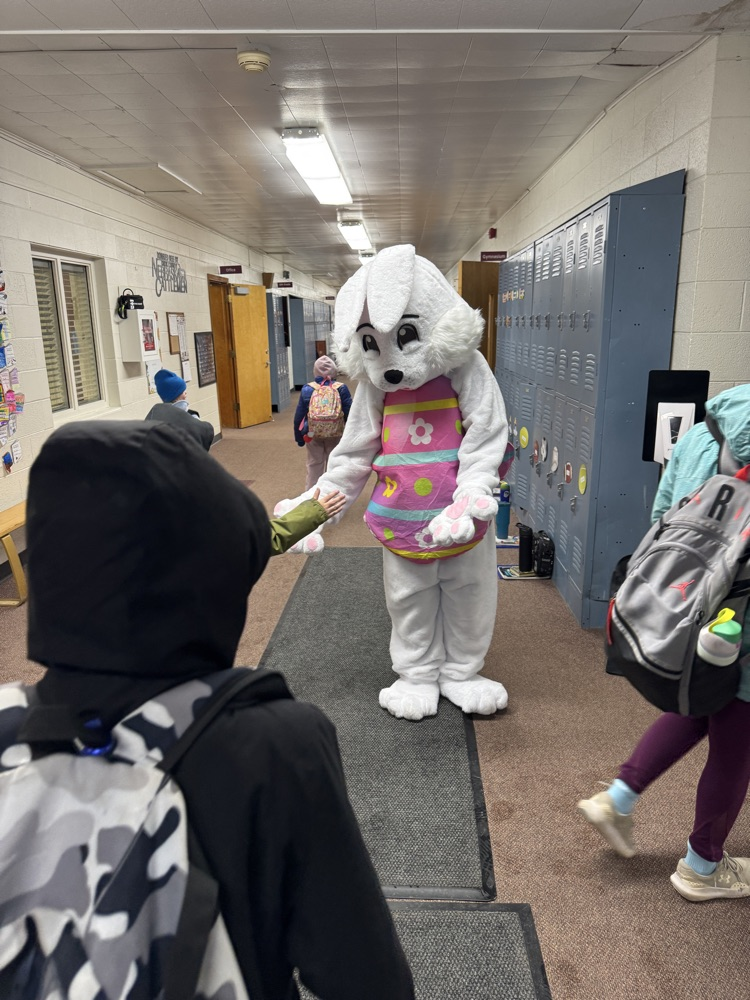 The Easter Bunny giving students high fives
