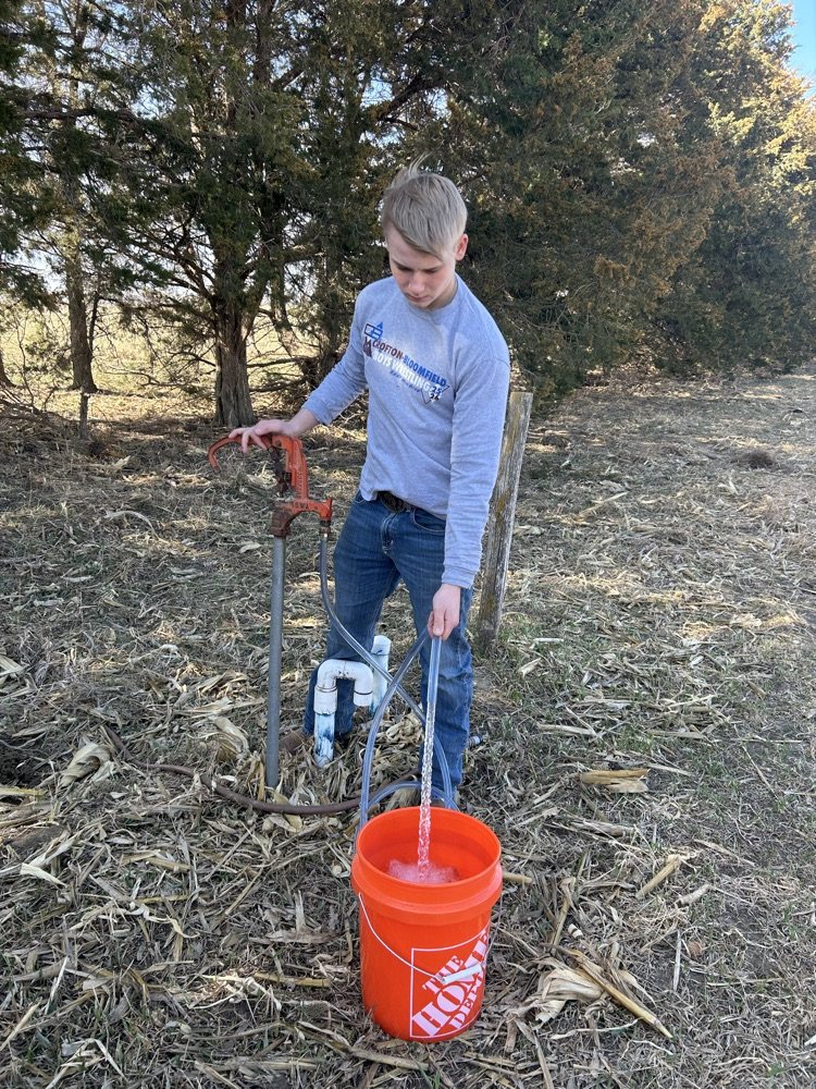 Student collecting a water sample