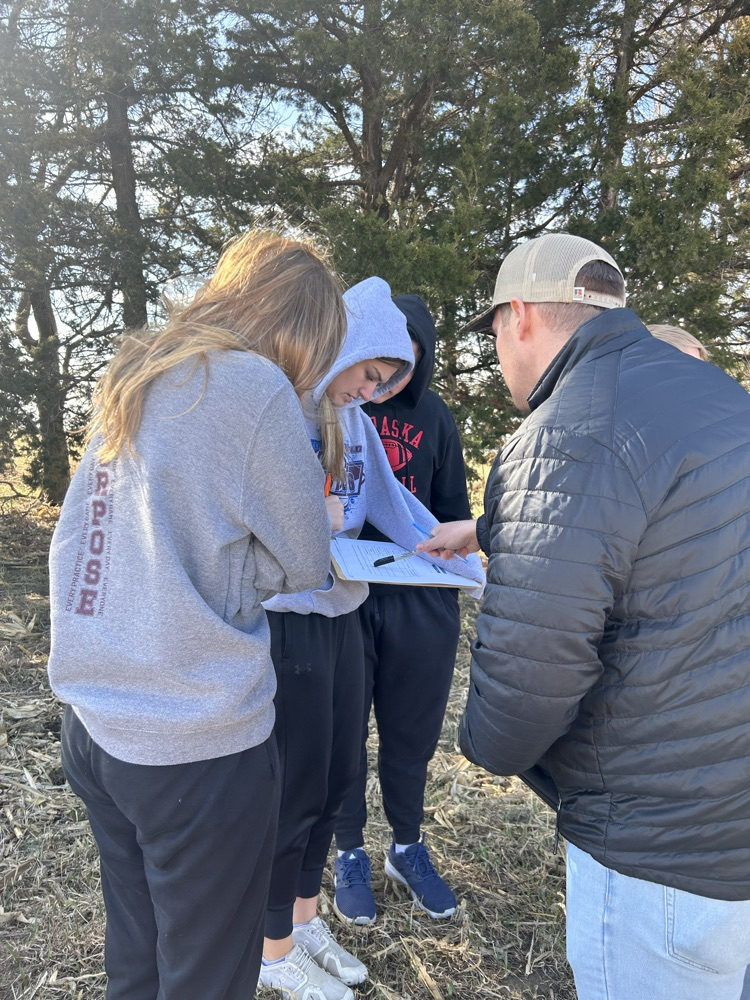 Students recording data at well site 