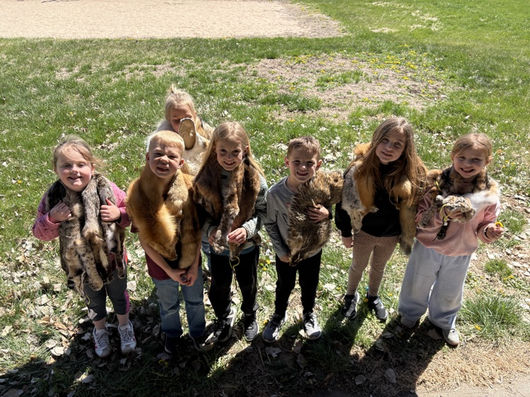 group of first graders with animal furs on their shoulders