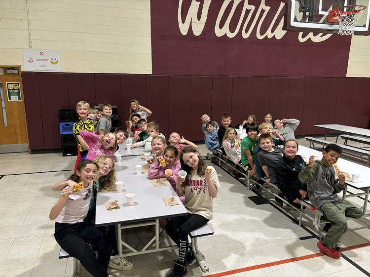 Third graders enjoying pizza and pop.